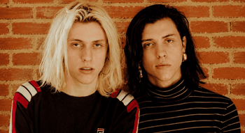 Os irmãos gémeos Wyatt e Fletcher Shiers, da dupla The Garden, em frente a uma parede de tijolos