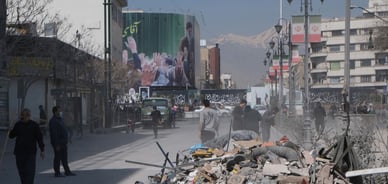 Volunteers clean up the rubble outside a government building in Tehran