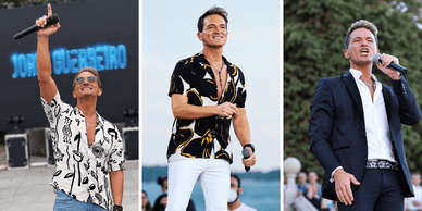 O cantor Jorge Guerreiro atua ao ar livre com uma camisa estampada e um blazer