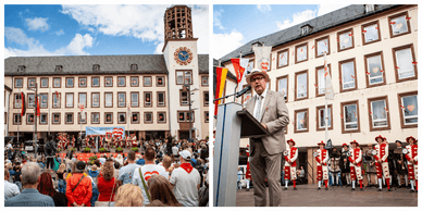 Menschenmenge vor dem Wormser Rathaus und ein Redner am Podium bei der Eröffnung des Backfischfestes