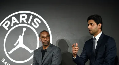 Conférence de presse PSG avec dirigeants et logo en arrière-plan.