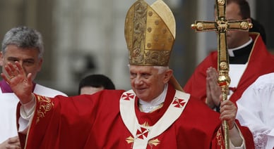 Le pape Benoît XVI en vêtement liturgique rouge bénit les fidèles pendant la visite du pape Benoît XVI au Portugal.