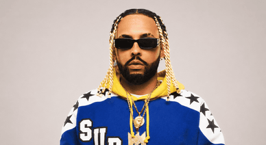 Retrato de Mizzy Miles com um casaco azul e amarelo da Supreme com estrelas e correntes douradas