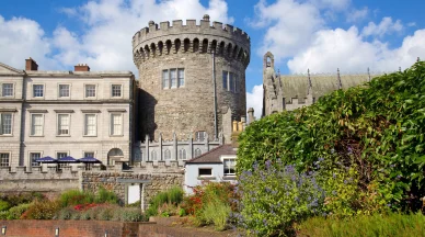 The medieval Record Tower at Dublin Castle, built around 1228, standing prominently with the Chapel Royal positioned to its left, both structures viewed from the Lower Courtyard.