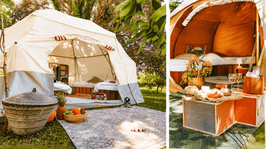 Interior de uma tenda de glamping com cama e mesa com comida