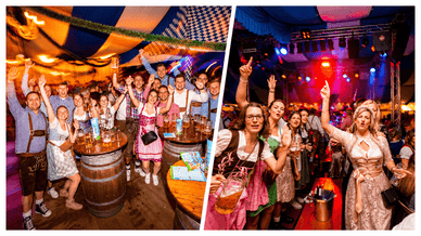 Feiernde Gäste in Dirndl und Lederhose im Festzelt