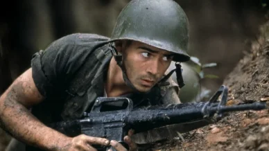 Colin Farrell as Private Roland Bozz in his breakout Hollywood role in the war drama Tigerland, wearing Vietnam War–era military fatigues and army gear.