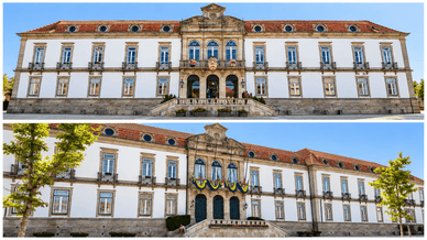 Fachada branca e granítica, com máscaras de carnaval na varanda