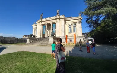 Public et façade du ZOOM de Laval lors d’une visite culturelle. Visiteurs devant l’entrée principale du ZOOM de Laval par une journée ensoleillée.