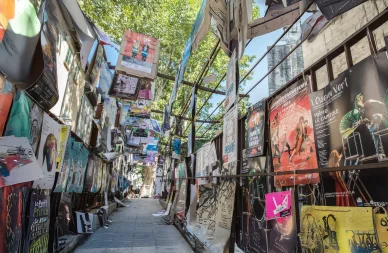 Affiches de spectacles alignées dans une rue du Festival d’Avignon.