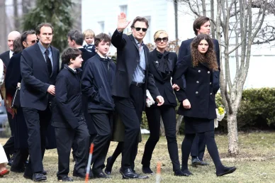 Liam Neeson (waving) with sons Micheal Neeson (3L), and Daniel Neeson (2L), and Joely Richardson arriving for the funeral of actress Natasha Richardson at St. Peter's Lithgow Episcopal Church on March 22, 2009 in Lithgow, New York