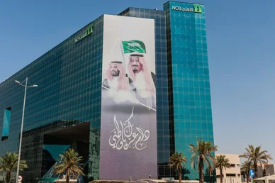 مبنى البنك الأهلي (NCB) خلال احتفالات اليوم الوطني السعودي مبنى البنك الأهلي (NCB) بواجهة زجاجية مزين بصورة الملك سلمان وولي العهد احتفالاً باليوم الوطني