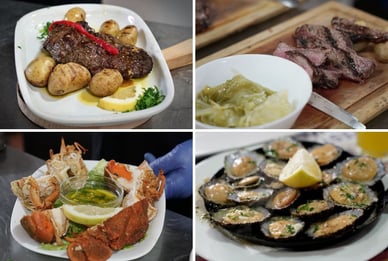 Pratos do Festival de Gastronomia de Santarém: bife com batata assada e pimentão, carne fatiada com couve refogada numa tábua, caranguejo com molho de ervas e limão, lapas fritas com alho na frigideira